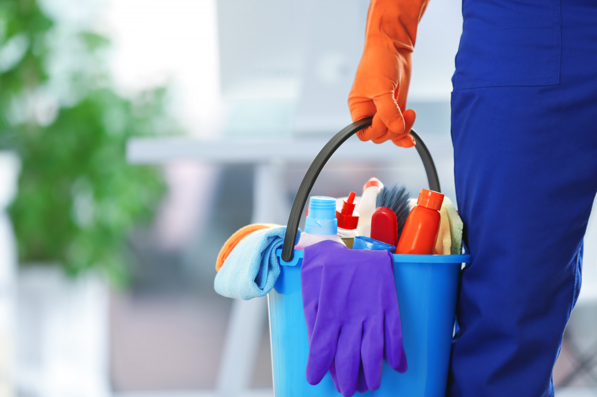 Friendly cleaning team with equipment